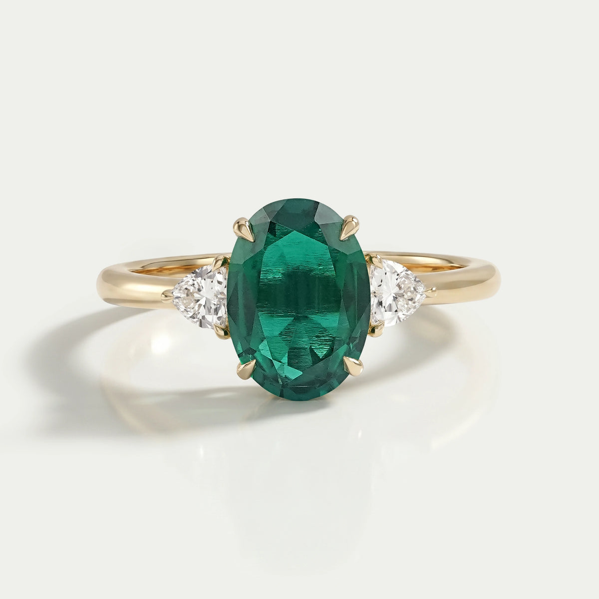 Trilogy Zambian Green Oval Gemstone And Trillion Cut Ring Ring